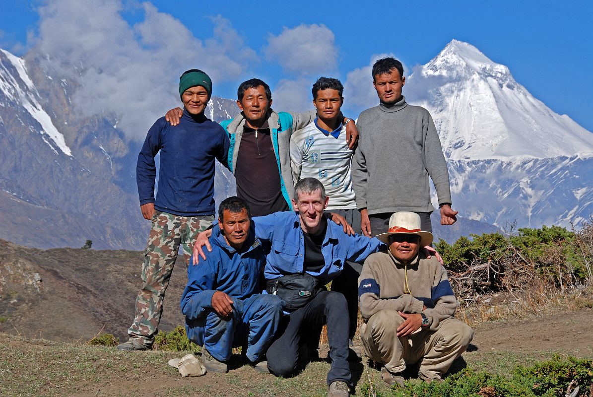 08 Team Photo On Way To Mesokanto La. Kneeling Gyan Tamang, Jerome Ryan, Kumar. Standing Tenzin, Mingma, Pemba Rinji, Nima Dorje Team photo on the way from Jomsom to Mesokanto La: kneeling down are cook Kumar, Jerome Ryan, and guide Gyan Tamang; standing are porters Tenzin and Mingma, cooks helper Pemba Rinji, and porter Nima Dorje.